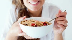 Eating a bowl of cereal with strawberries