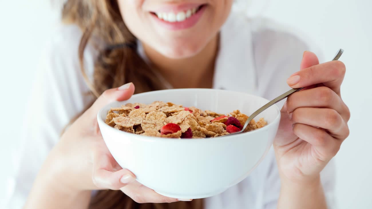 Eating a bowl of cereal with strawberries